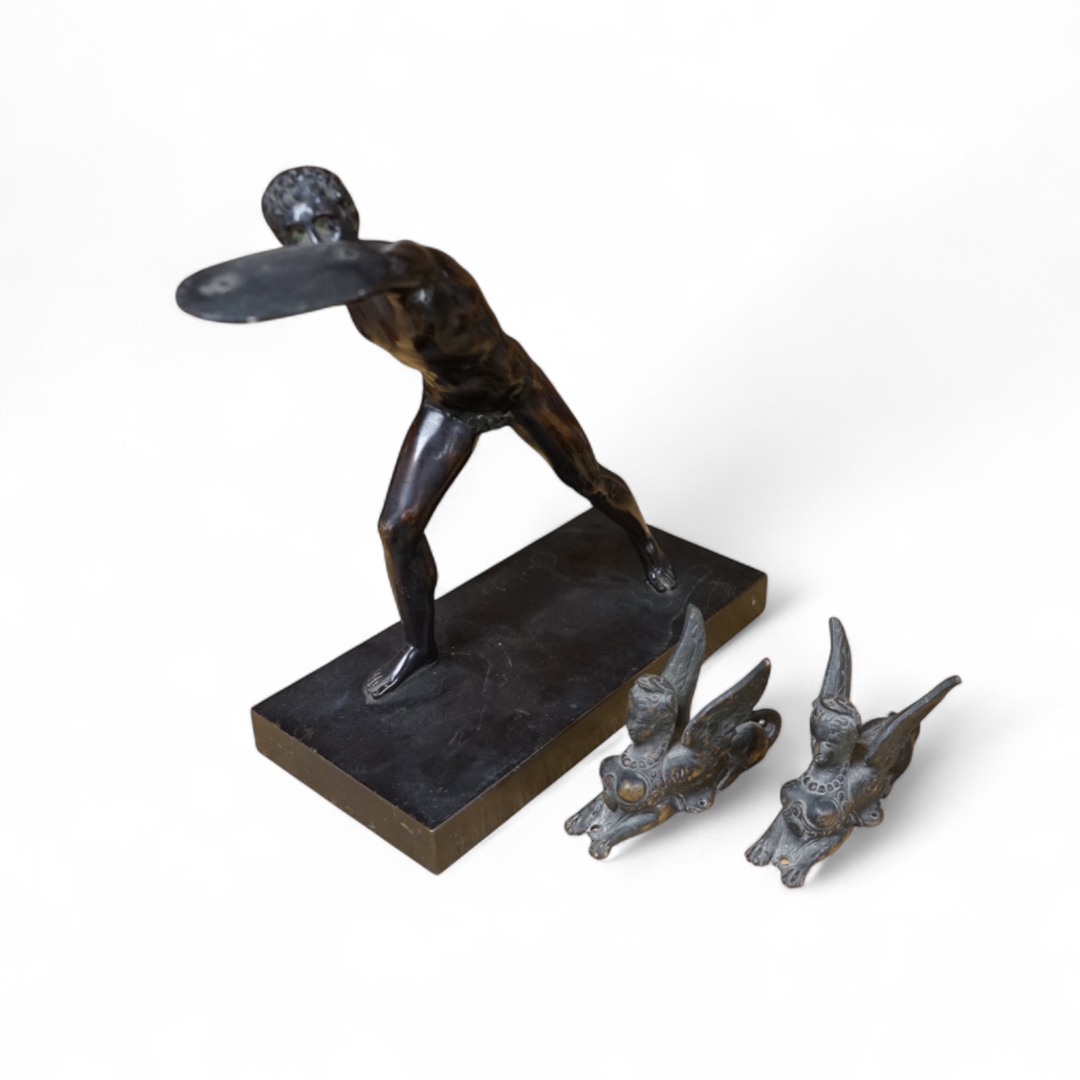 After the antique, a bronze figure of a warrior and two small studies of sphinx, largest 21cm high